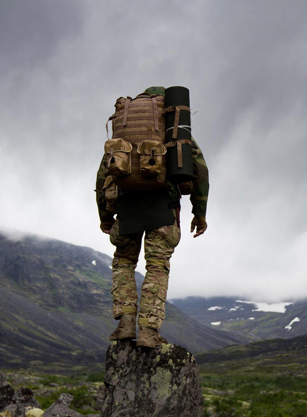 man in military gear in the wilderness